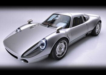 A silver Aerfal Automotive sports car with a sleek, aerodynamic design is parked on a white surface, viewed from the front left angle—a modern take that goes Beyond 911 with subtle 904 restomod influences.