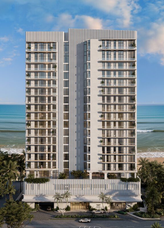 A modern high-rise apartment building with balconies, set against a beach and ocean backdrop, surrounded by palm trees and a clear blue sky, as Aston Martin expands its real estate empire with Daytona Beach Shores Residences.