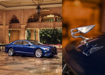 A blue Bentley luxury sedan is parked indoors beside ornate columns, reflecting the brand’s Indian presence; a close-up reveals its iconic winged hood ornament shimmering on the car’s front.