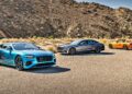 Three luxury cars—a blue coupe, a silver sedan, and an orange convertible—stand on a paved desert road as the First Ombré by Mulliner Collection arrives at Bentley Rancho Mirage with three bespoke commissions.