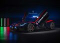 A Maserati MCPURA sports car with "Carabinieri" markings and upward-opening doors is displayed in a dimly lit room, joined by the Alfa Giulia Quadrifoglio, as Italy’s high-speed medical fleet shines under Italian flag lights in the background.