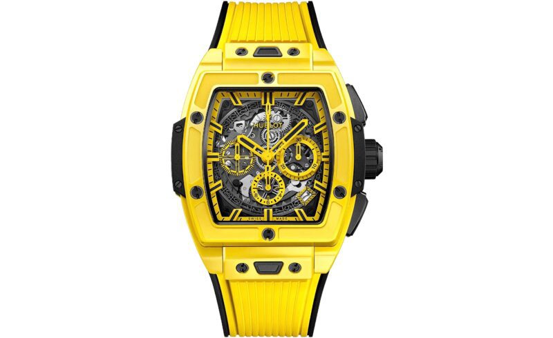 A yellow Hublot wristwatch with a rectangular skeleton dial, black accents, and a matching yellow rubber strap—an eye-catching choice for those seeking the best luxury watches.