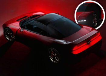 A red Honda NSX sports car with a black roof is viewed from above at an angle, with a circular inset highlighting its sleek LED front lights in this limited-run restomod edition.