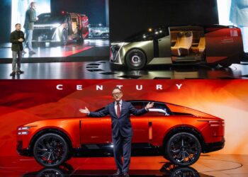 Two men present two futuristic concept SUVs on stage—one silver with open doors (top) and one red (bottom)—both under dramatic lighting at the 2025 Japan Mobility Show, showcasing the innovation of Century Brands and Lexus.