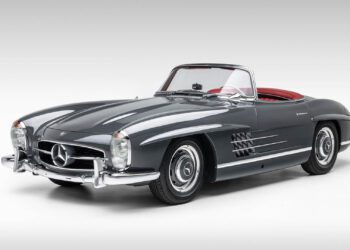 A classic grey Mercedes-Benz SLR McLaren convertible with a red interior, viewed from the front left against a plain white background—an iconic design destined for Broad Arrow’s Las Vegas 2025 event.