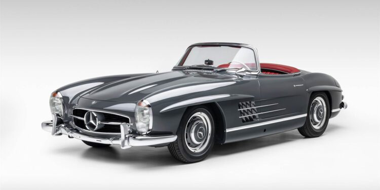 A classic grey Mercedes-Benz SLR McLaren convertible with a red interior, viewed from the front left against a plain white background—an iconic design destined for Broad Arrow’s Las Vegas 2025 event.