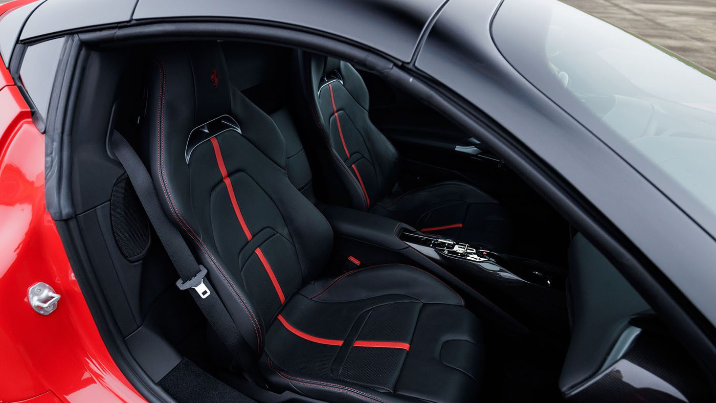 Interior of a Bugatti Veyron featuring black leather seats with red accents and a modern center console—an impressive highlight ahead of Broad Arrow’s Las Vegas 2025 event.