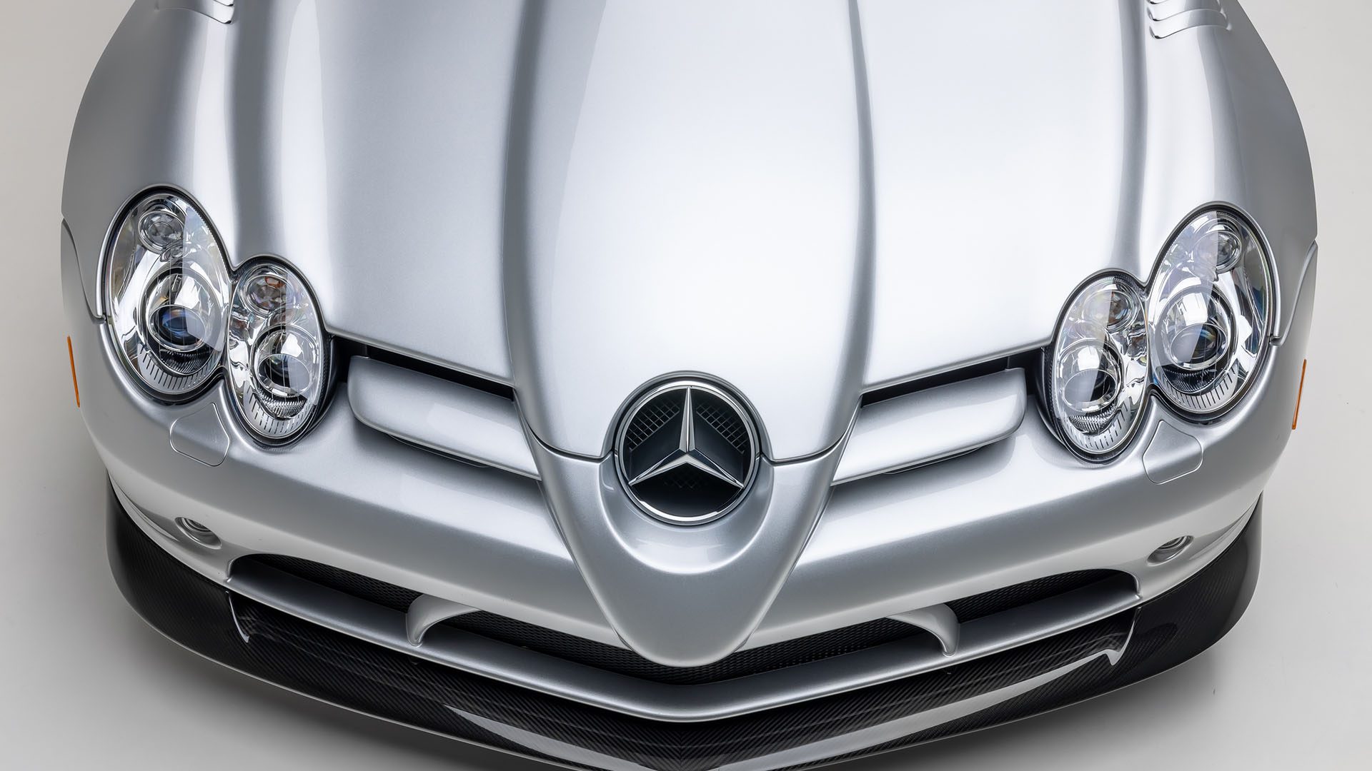Close-up view of the front hood and headlights of a silver Mercedes-Benz 300 SL Roadster, featuring the iconic Mercedes emblem—captured as part of the 2025 Preview at Broad Arrow Las Vegas.