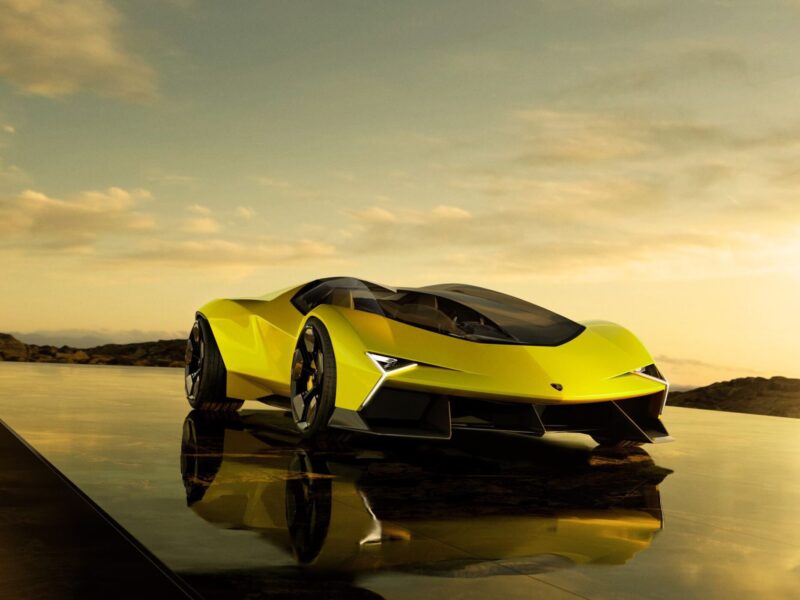 A yellow futuristic sports car with sharp angles and black accents, reflecting How Centro Stile Is Shaping the Future of Lamborghini Design, is parked on a reflective surface under a golden sky.