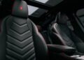 Black leather seats with red stitching and Maserati logos grace the Grecale Folgore’s sunroofed cabin, showcasing modern interior design and advanced EV tech.