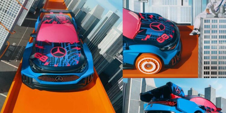 A blue and pink Mercedes-Benz toy car, inspired by the Mercedes-Benz CLA Gets Wild Hot Wheels Makeover, races down an orange track amid model skyscrapers, with a person sitting on a building in the background.