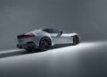 A silver Ferrari 12Cilindri sports car with NOVITEC customizations is parked in a studio setting, viewed from the rear side under soft lighting.