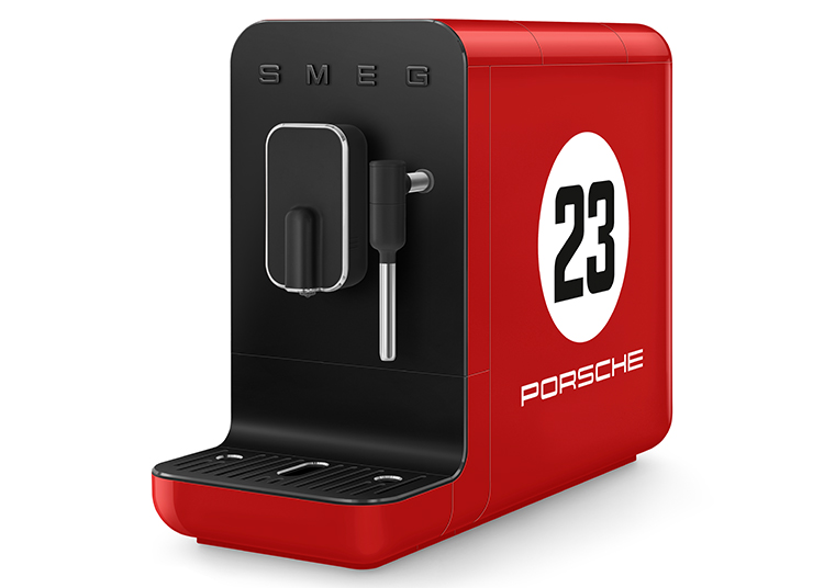Red SMEG espresso machine with black front panel, featuring a white circle with the number 23 and "Porsche" text on the side. A standout piece for any Kitchen Collection.