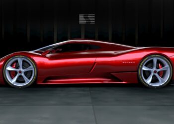 A red sports car with sleek aerodynamic design and large silver wheels is parked indoors on a tiled floor with a dark background.