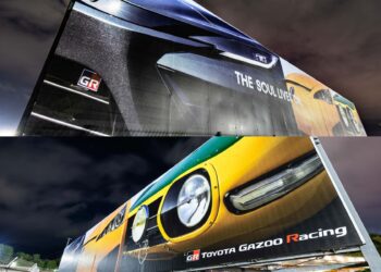 Two billboards at night display close-up images of Toyota sports cars with "GR" and "Toyota Gazoo Racing" branding, hinting at a Toyota teaser for a possible new Toyota halo car inspired by Fuji Speedway.