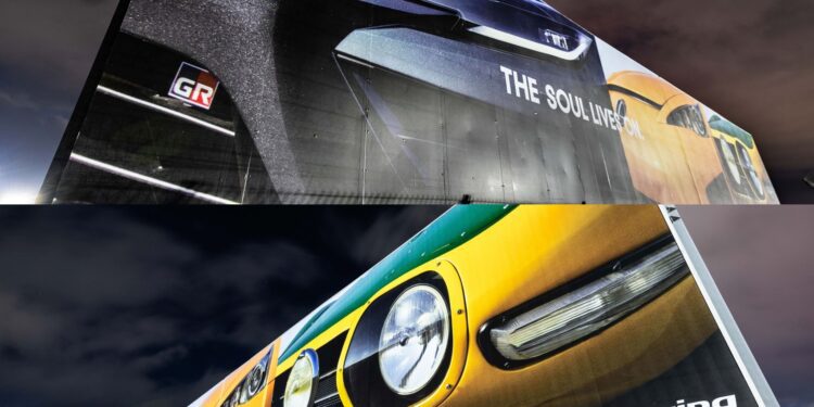 Two billboards at night display close-up images of Toyota sports cars with "GR" and "Toyota Gazoo Racing" branding, hinting at a Toyota teaser for a possible new Toyota halo car inspired by Fuji Speedway.