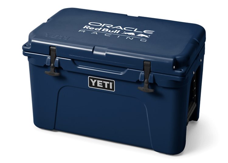 A dark blue YETI cooler with black latches features striking "Oracle Red Bull Racing" F1 branding on the lid in white and light blue text.