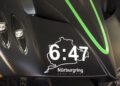 Close-up of a Pagani’s carbon fiber hood featuring "6:47," the Nürburgring track outline, and "Nürburgring Nordschleife" text—capturing the essence of hypercars at Auto e Moto d'Epoca.