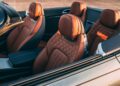 Close-up view of the front and rear seats of a luxury convertible car with brown leather upholstery and detailed stitching, inspired by Bentley Honors Wartime Heroes with the Czech Squadron Collection and 2025 Remembrance Car.