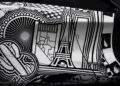 Close-up of a car with black and white abstract artwork, featuring geometric shapes, stripes, and a stylized Eiffel Tower—Project Viva Revealed: One-of-One McLaren 750S Spider Brings Las Vegas to Life among other graphic elements.