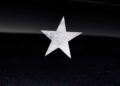 A single white five-pointed star is centered on a glossy black surface, echoing the exclusivity of Project Viva Revealed: One-of-One McLaren 750S Spider Brings Las Vegas to Life.