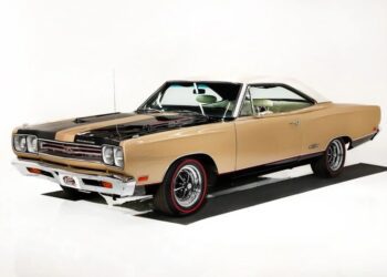 A vintage beige and black two-door classic muscle car with chrome accents is parked on a white background, viewed from the front driver's side—a timeless choice for fans of high-performance cars.
