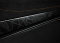 Close-up of a car interior door panel featuring black and gray geometric patterns, orange stitching, and the word "AMG" visible on the trim—reminiscent of the custom flair seen in Project Viva Revealed: One-of-One McLaren 750S Spider Brings Las Vegas to Life.