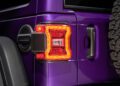 Close-up of the rear left taillight and part of the spare tire on a purple SUV, inspired by Jeep’s 85th Anniversary Limited Edition Series with the Moab 392.
