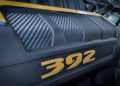 Close-up of a car engine cover featuring a carbon fiber pattern and the number "392" in gold letters—highlighting the first of 12 Jeep 85th Anniversary Limited Edition Moab 392 models.