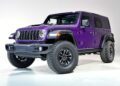 A purple four-door Jeep Wrangler Moab edition, part of Jeep’s 85th Anniversary Limited Edition Series with the Moab 392, is parked in a well-lit studio with a plain white background.