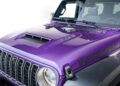 Close-up of the front and hood of a purple Jeep Wrangler “MOAB 392,” celebrating Jeep’s 85th Anniversary Limited Edition Series, with a hood vent, signature decals, and part of the windshield visible.