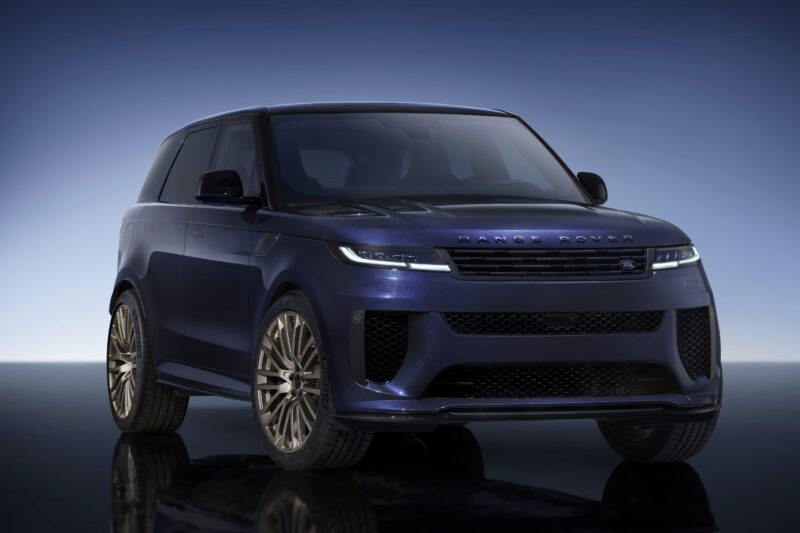 A blue Range Rover SUV is shown from the front angle, with large alloy wheels and a dark gradient background, highlighting the Range Rover Expands 2026 Sport Lineup with SV Black SV Carbon and SV Bespoke Editions.