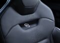 Close-up of a black perforated leather car seat with a white illuminated logo in the center, showcasing the luxurious design featured in the Range Rover Expands 2026 Sport Lineup with SV Black SV Carbon and SV Bespoke Editions.