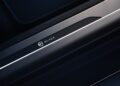 Close-up of a car door sill plate with the word "BLACK" and a logo, featuring a metallic strip and dark trim—highlighting the style seen in the Range Rover Expands 2026 Sport Lineup with SV Black SV Carbon editions.