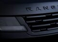 Close-up of the front grille and headlight of a black Range Rover vehicle, with the "RANGE" lettering partially visible, highlighting the bold design featured in the 2026 Sport lineup and new SV Black editions.