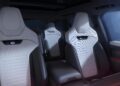Modern car interior featuring four light gray, high-backed seats with headrests, black accents, and minimalist design—reminiscent of the refined style found in the new Range Rover Expands 2026 Sport Lineup with SV Black editions.