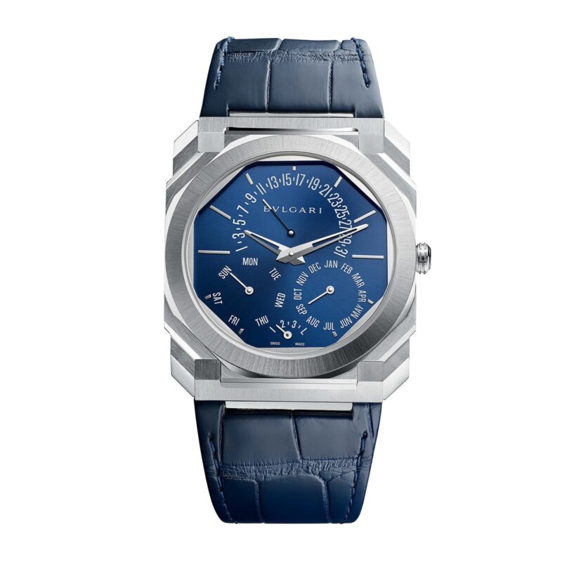 A Bulgari wristwatch with a blue dial featuring day, date, and month subdials, set in a silver case with a blue leather strap—an elegant choice among the best luxury watches.