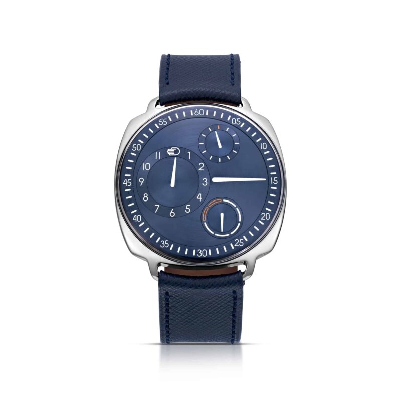 A modern wristwatch with a blue dial, unique subdials, and a blue leather strap is showcased against a white background—an elegant example among the best luxury watches.