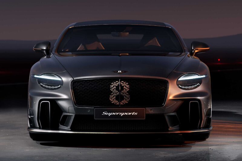 A matte black Bentley Supersports Continental GT viewed from the front, showcasing its headlights, prominent grille, and "Supersports" badge—a truly driver-focused sports car.