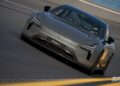 A silver Polestar 5 electric car races on a track with a driver and passenger visible inside in Gran Turismo 7, showcasing sleek design and speed. This thrilling scene was captured in-game during December.