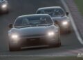 A Polestar 5 leads another car on a race track during a Gran Turismo 7 simulation, both vehicles navigating a curve in the December update.