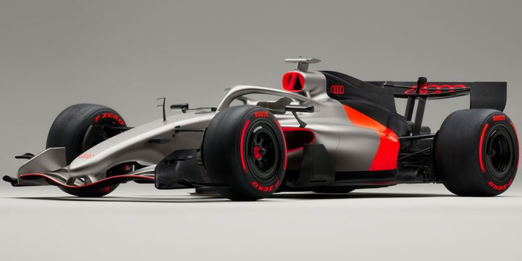 A silver and black Audi R26 concept Formula 1 race car featuring red accents, Pirelli tires, and Audi branding, shown on a plain gray background—ready for its Formula 1 debut in Melbourne.