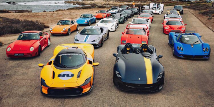A group of high-performance sports cars, including Ferraris, Pagani, and Porsche models, line a coastal road—an impressive scene as the U.S. luxury automotive market is set to surpass $200 billion by 2035, according to a comprehensive BCG study.