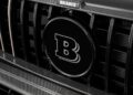 Close-up of a car grille featuring a large "B" emblem and "BRABUS" above, showcasing carbon fiber detailing—highlighting the craftsmanship seen in the Brabus Debuts 800 Cabrio and XL 800 Cabrio.
