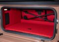 Open car trunk with a bright red, quilted mat, internal crossbars, a light, and a speaker visible inside—perfect for fans as Brabus debuts the 800 Cabrio and XL 800 Cabrio.