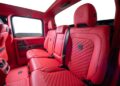 The image shows the rear seats of a vehicle interior with bright red quilted leather upholstery and black seat belts, reminiscent of the luxurious style seen when Brabus debuts 800 Cabrio and XL 800 Cabrio models.