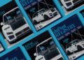 Multiple copies of the December 2025 duPont REGISTRY magazine are arranged on a blue surface, featuring a white luxury SUV on the cover.
