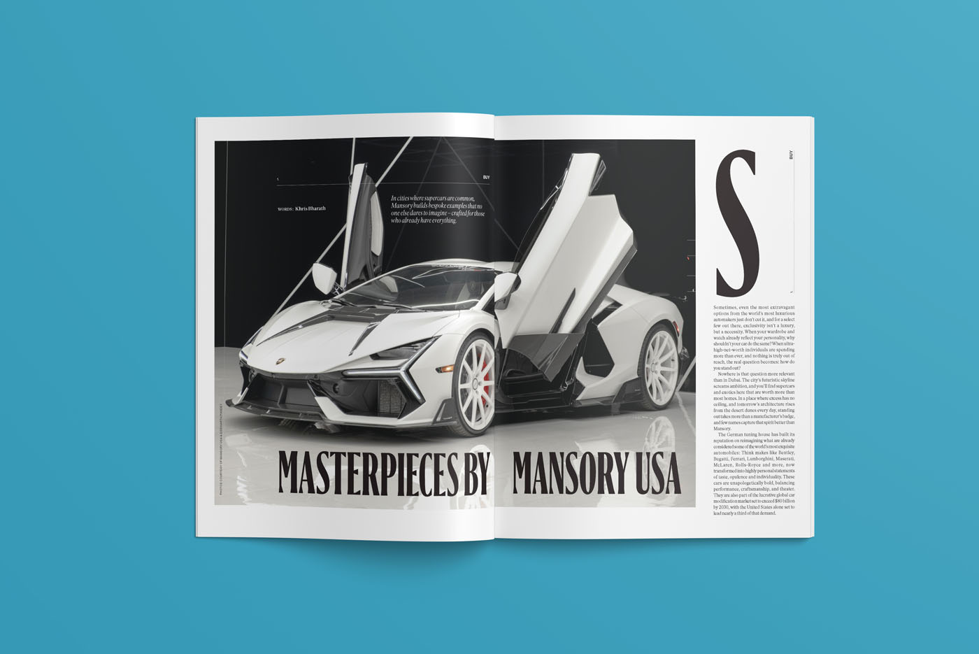Magazine spread from duPont REGISTRY, December 2025, showcases a silver sports car with its doors open upward, under the headline "Masterpieces by Mansory USA" set against a striking blue background.
