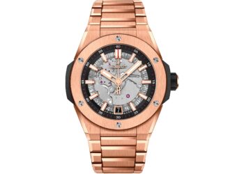 A rose gold Hublot wristwatch with a metallic bracelet, exposed movement on the dial, black accents, and a date window at 6 o'clock—an exquisite choice among the best luxury watches.
