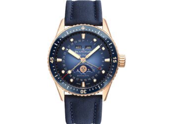 A gold Blancpain wristwatch with a blue dial and strap, featuring day, date, and moon phase displays plus luminescent hour markers—a standout among the best luxury watches.
